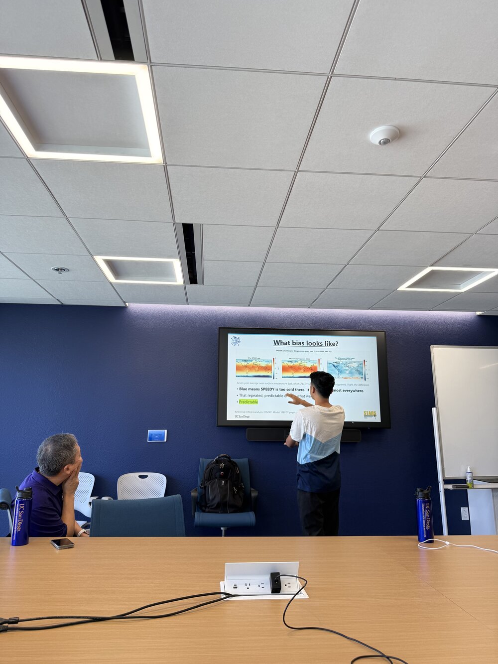 A Pathways student presenting climate research to a mentor